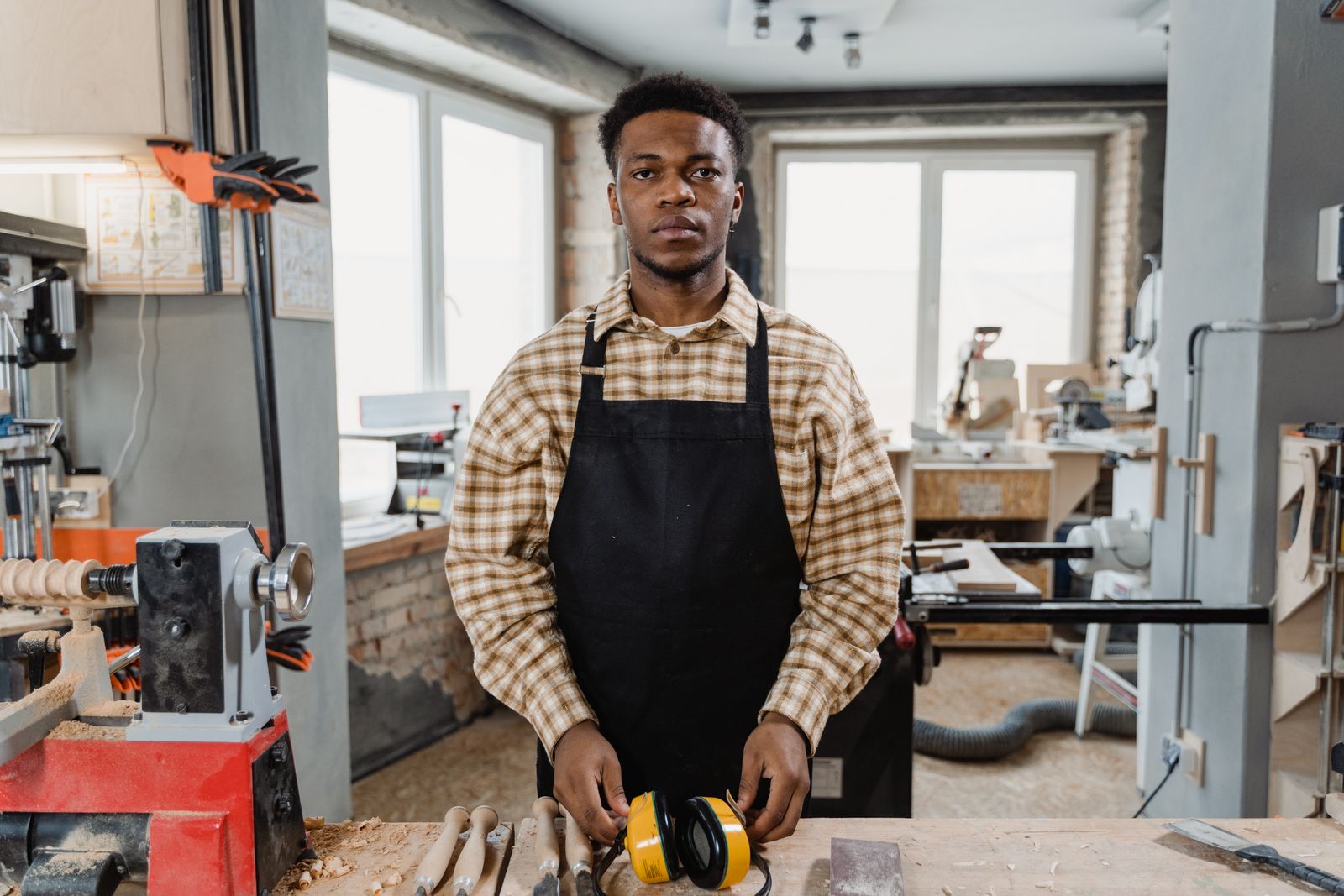 A man in an apron working in his workshop