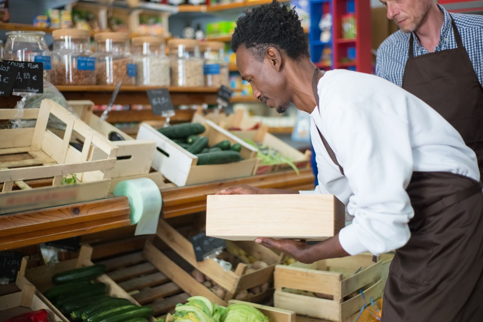 A man holding a crate of produce