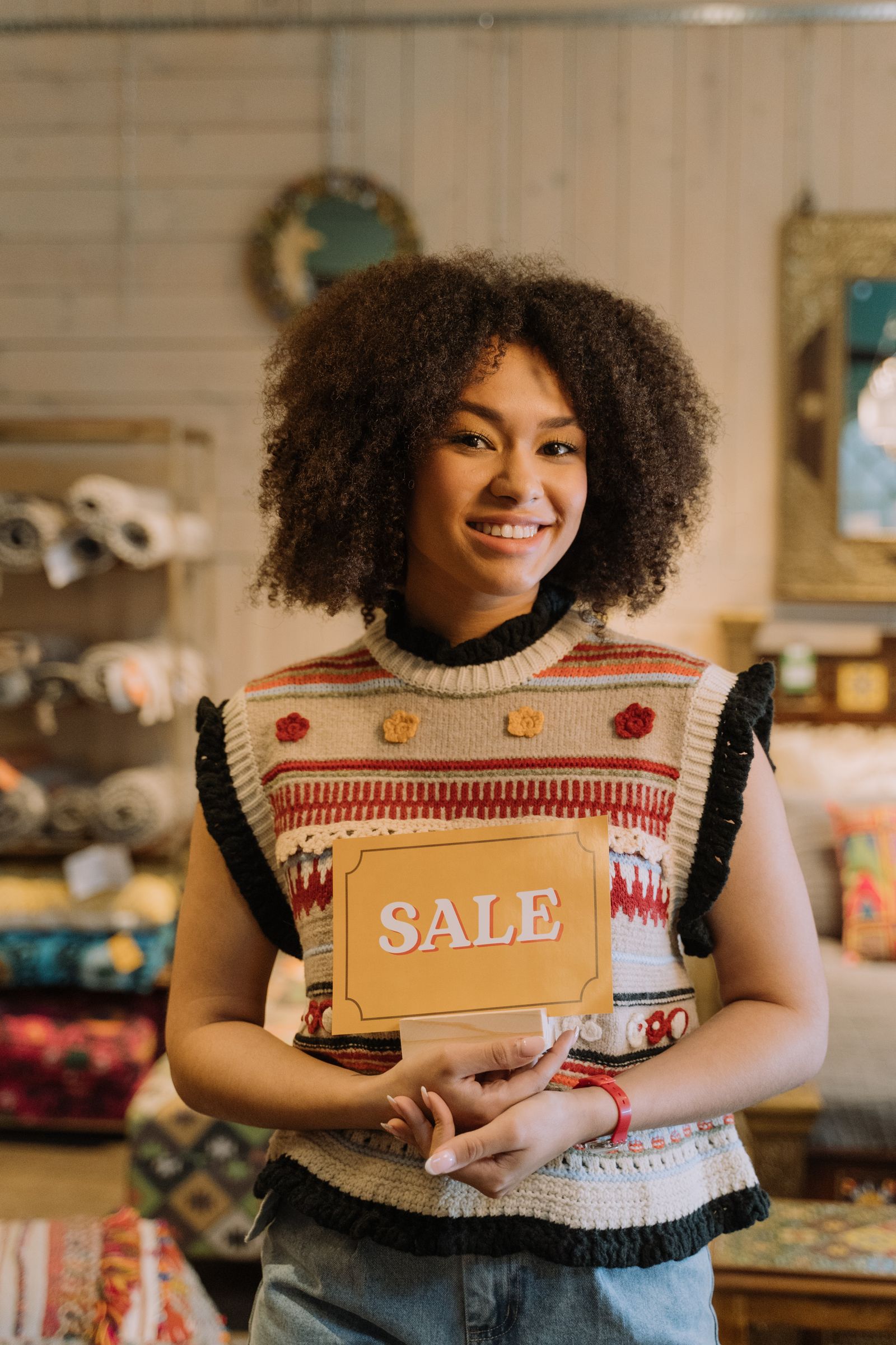 Smiling woman holding a sale card